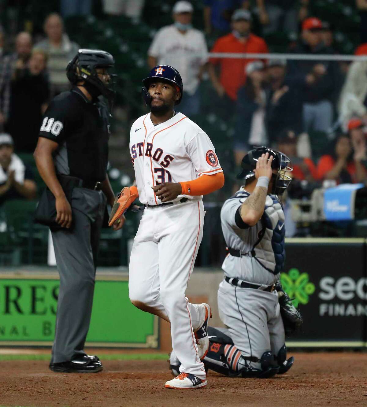 Houston Astros Ronnie Dawson (31) scores a run as Yuli Gurriel was walked with the bases loaded during the ninth inning of an MLB baseball game at Minute Maid Park, in Houston, Wednesday, April 14, 2021.