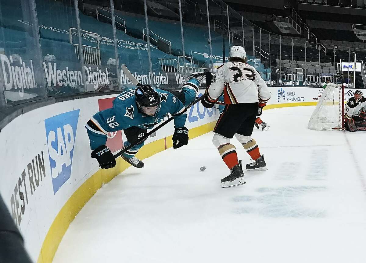 Sharks left wing Rudolfs Balcers (92) is sent flying after being checked against the boards by Ducks center Sam Steel (23) during the first period of Anaheim’s win at SAP Center.
