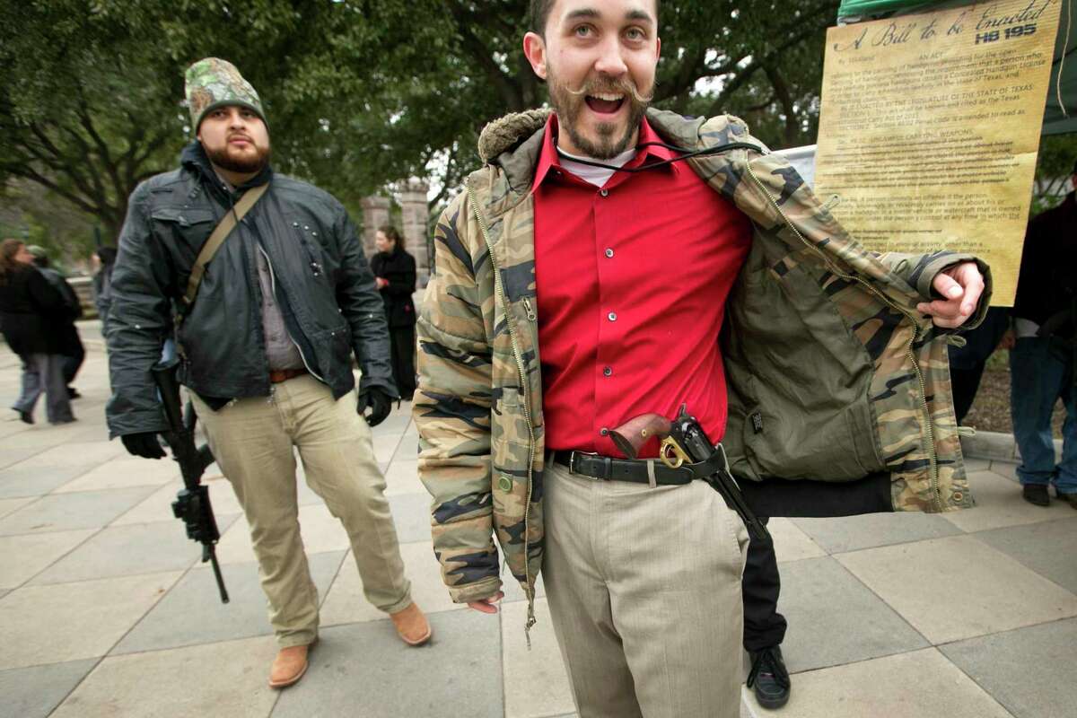 Ben Franklin, right, of Arlington, Texas, carries an 1858 black powder pistol at a rally to support HB 195, which would allow the open carry of handguns with no permitting or background check requirements, at the Capitol, Tuesday, January 13, 2015, in Austin, Texas. (AP Photo/Austin American-Statesman, Jay Janner) AUSTIN CHRONICLE OUT, COMMUNITY IMPACT OUT, INTERNET AND TV MUST CREDIT PHOTOGRAPHER AND STATESMAN.COM, MAGS OUT
