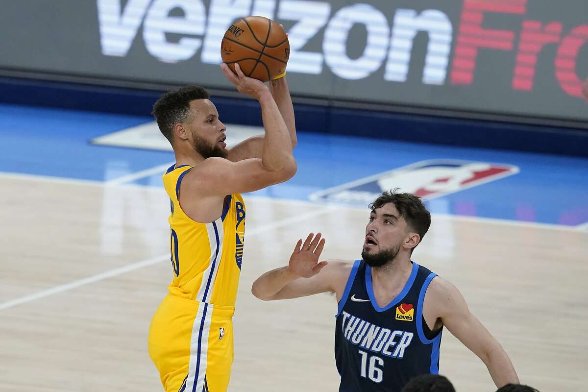 Golden State Warriors guard Stephen Curry, left, shoots over Oklahoma City Thunder guard Ty Jerome (16) in the second half of an NBA basketball game Wednesday, April 14, 2021, in Oklahoma City. (AP Photo/Sue Ogrocki)