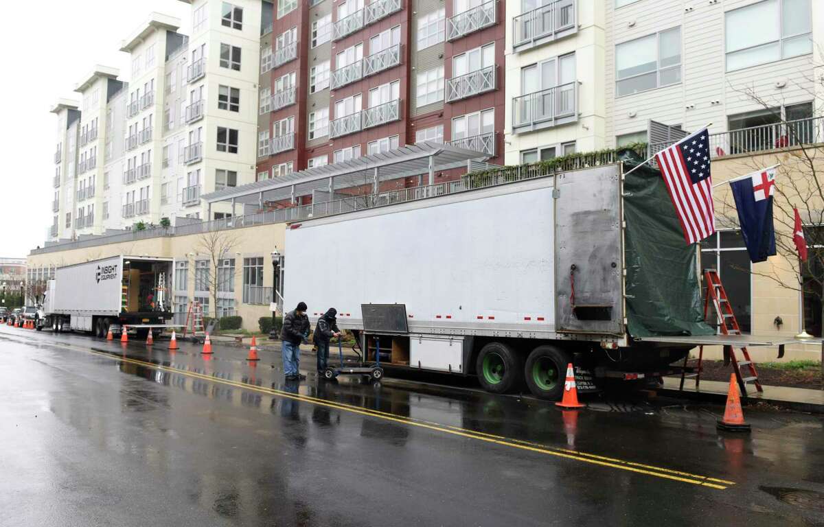 Large trucks line the street where "The Good Nurse" is being filmed in Stamford, Conn. Thursday, April 15, 2021. The upcoming Netflix true crime film stars Eddie Redmayne playing Charles Cullen, who murdered anywhere between 40 and 300 patients while working in critical care units across New Jersey and Pennsylvania. Cullen's coworker and friend, played by Jessica Chastain, eventually helped take him down. The movie is being filmed in the medical building at 90 Morgan Street until Friday, where it will then migrate to a residential block in the Waterside neighborhood of Stamford.