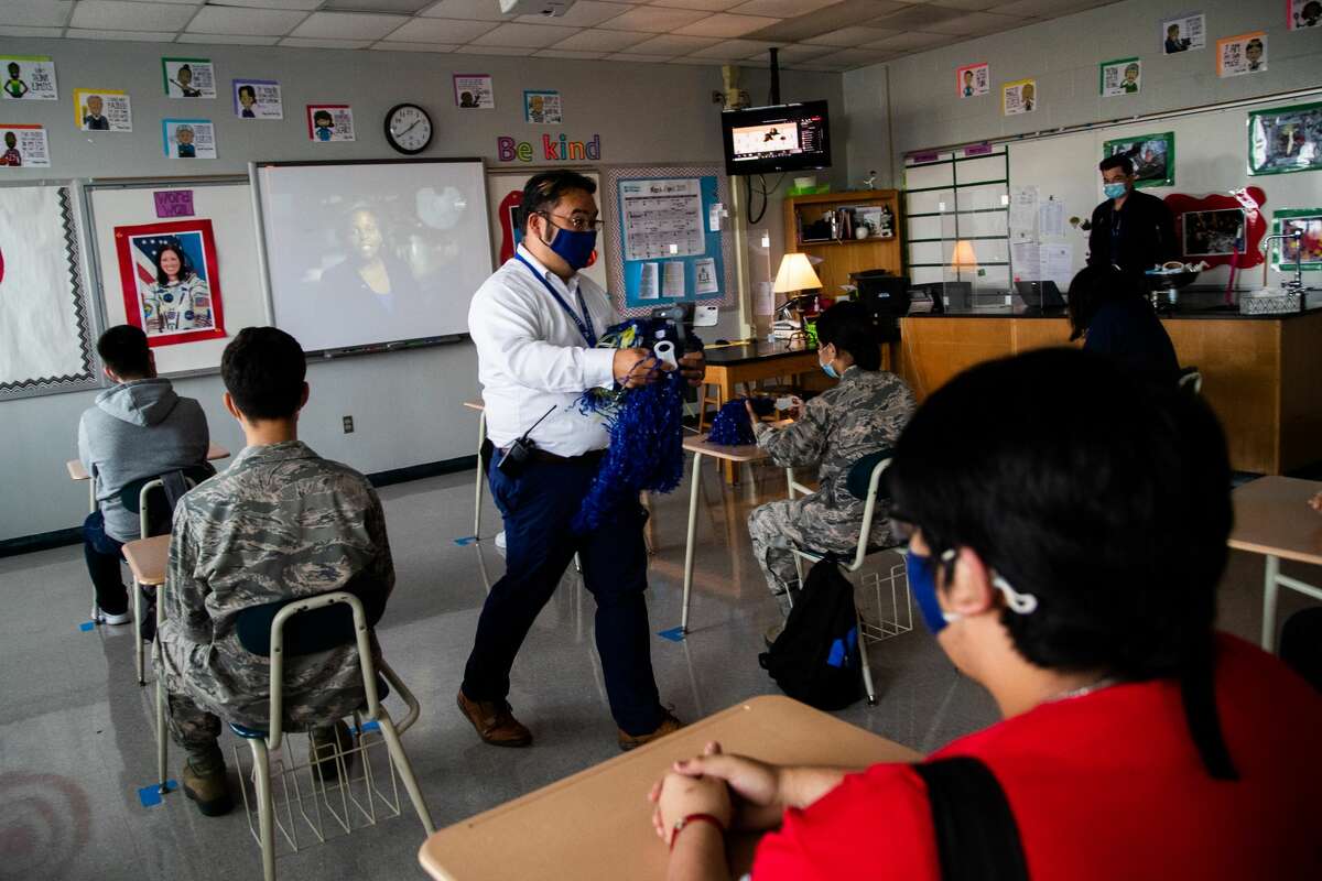 Westbury High School assistant principal Will Rice distributes pom-poms to students ahead of the ceremony from space on which NASA astronaut Shannon Walker becomes commander of the International Space Station, Thursday, April 15, 2021, in Houston. Walker is a 1983 graduate of Westbury High School.