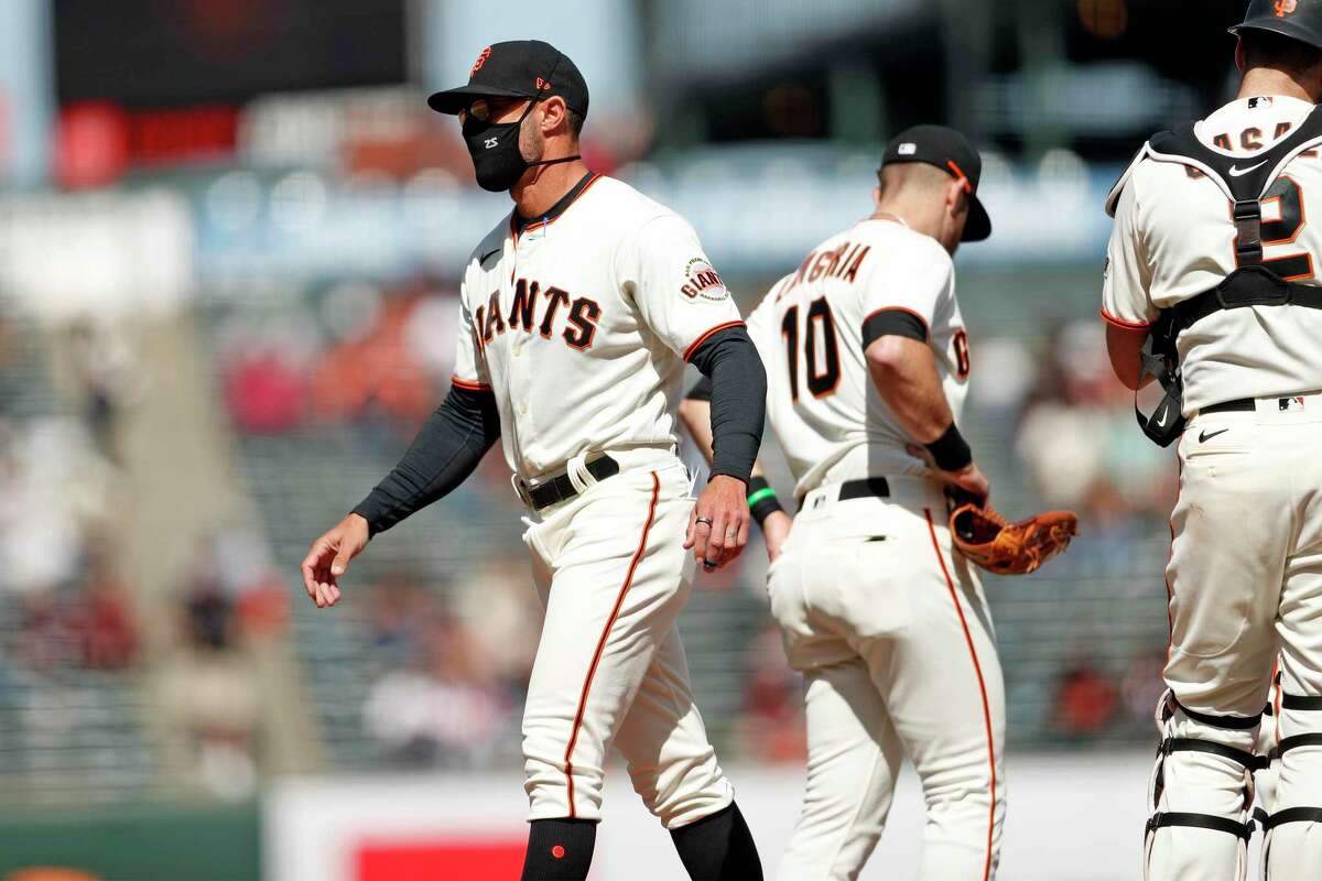 San Francisco Giants' manager Gabe Kapler heads back to the dugout after making a pitching change in 7th inning against Colorado Rockies during MLB game at Oracle Park in San Francisco, Calif., on Sunday, April 11, 2021.