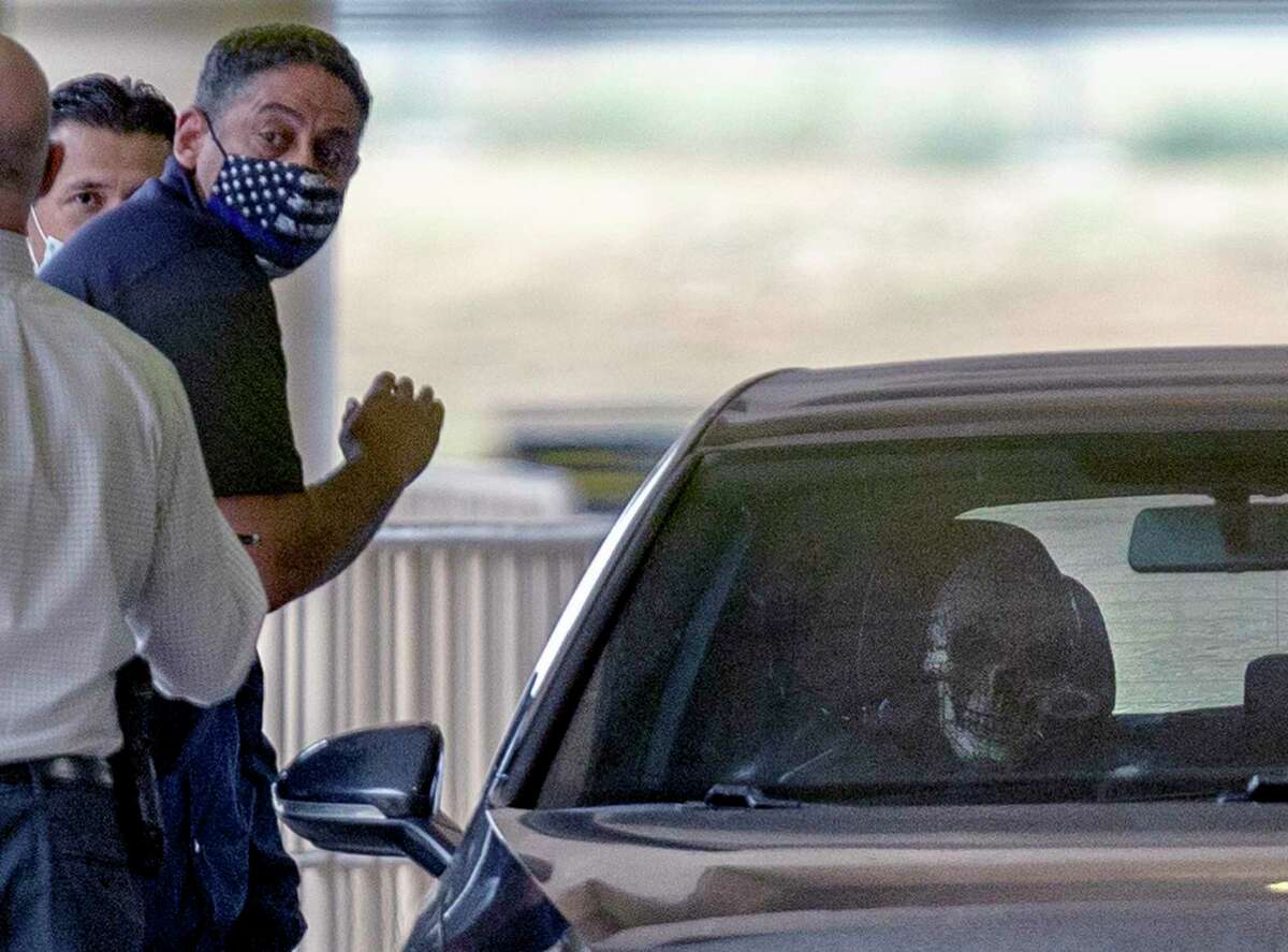 San Antonio police investigate what appears to be a skeleton or skeleton mask sits Thursday, April 15, 2021 in a vehicle Thursday, April 15, 2021 at the San Antonio International Airport after an officer involved shooting. The Volkswagen sedan with dibbled veteran plates was facing the wrong direction in the passenger pickup lanes of the airport terminal. The airport terminals were evacuated and secured by gates at the TSA checkpoints as a precaution, according to police.