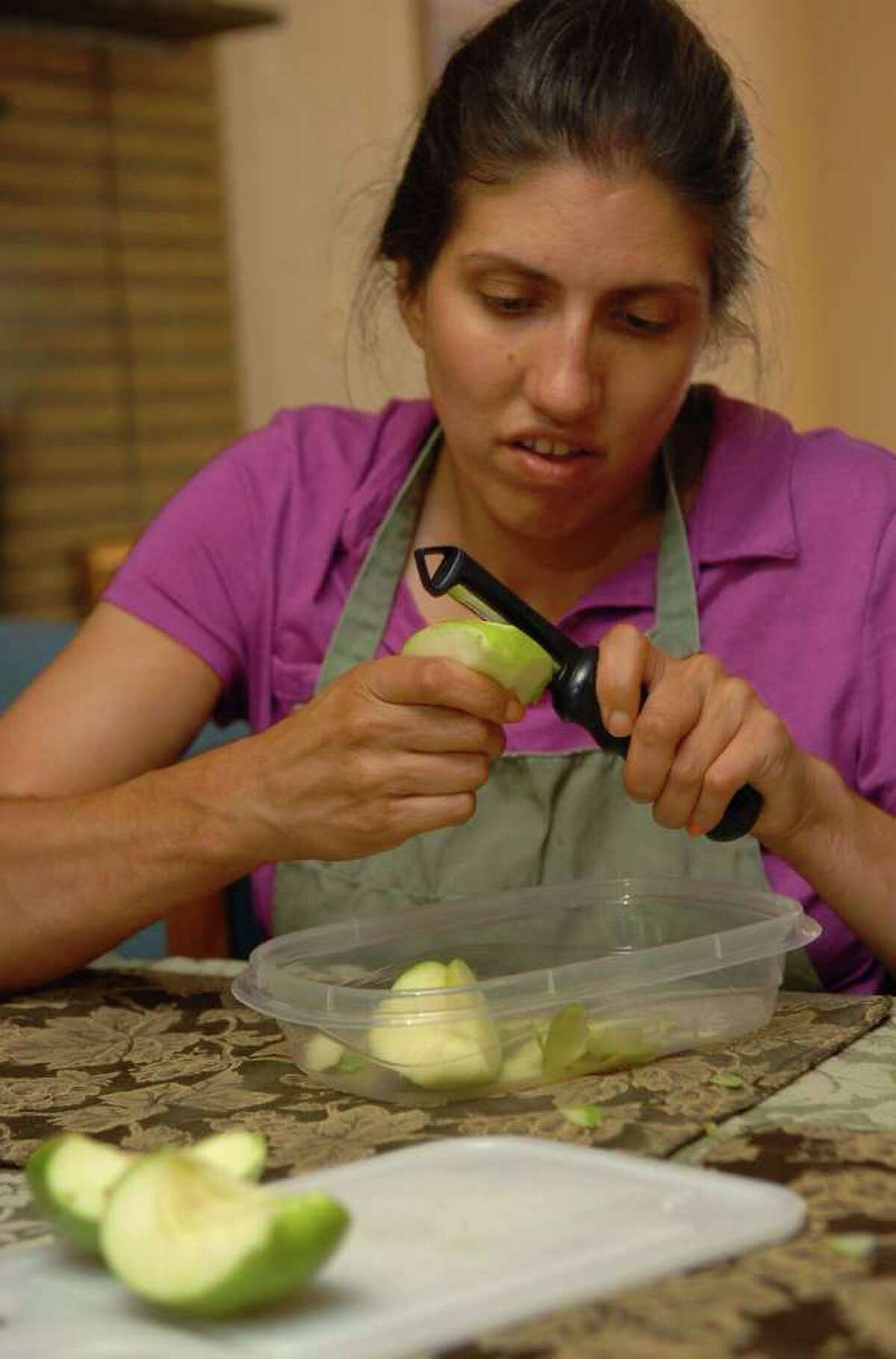 Brita Darany von Regensburg is the founder of Friends of Autistic People, a Greenwich based nonprofit organization that is working to create opportunities for adults with autism. Brita's daughter Vanessa Darany, who has autism, lives at a group home in Trumbull and would benefit from the organization. Here, she peels some apples for an apple pie while at the home in Trumbull, Conn. on Friday August 13, 2010.