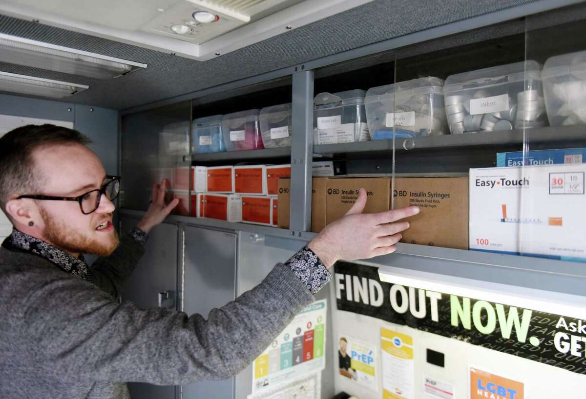 Luke Grandis, program coordinator at Project Safe Point, shows boxes of hypodermic needles stored in Safe Point's needle exchange van on Wednesday, April 11, 2018, in Albany N.Y. The program strives to improve the health and quality of life of people who use drugs in the Capital Region. (Will Waldron/Times Union)