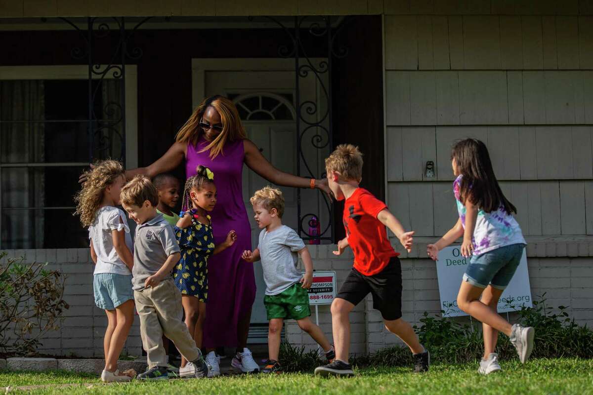 Ashley Jackson, 38, center, a resident of Oak Forest mobilizes the children from her neighborhood as they spend the afternoon together playing outside, Monday, April 12, 2021, in Houston.