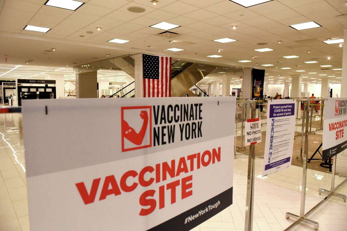 New signage is in place inside the former Lord and Taylor store at Crossgates Mall which has been transformed into a state COVID-19 vaccination site on Friday, April 16, 2021, in Guilderland, N.Y. New York said it will reopen the Queensbury mass vaccination site Dec. 1, 2021 as cases continue to rise in rural New York. (Will Waldron/Times Union)
