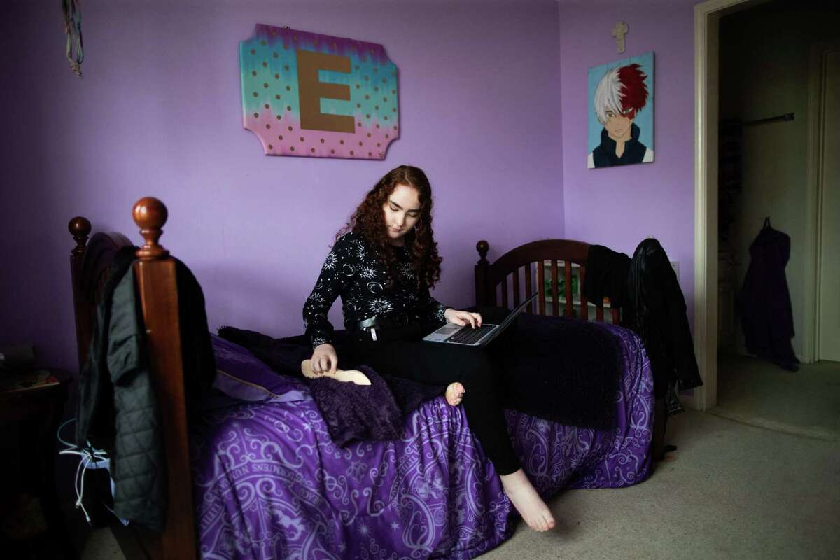 Beck Junior High School eighth-grader Ellen Holden sits on her bed with her laptop at her Katy home Thursday, April 15, 2021. Holden hopes to spend her high school freshman year in virtual instruction after performing well in online classes this year.