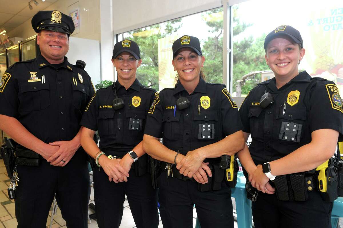 From left, Trumbull police officers Tim Fedor, Kelly Brown, Theresa Massa and Emily Gisvold on Aug. 16, 2019. The yellow Tasers are visible on the left side of Massa and Gisvold’s belts. The officers’ duty pistols are holstered on the right.