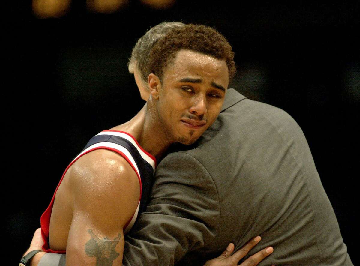 University of Connnecticut's Kevin Freeman hugs coach Jim Calhoun after UConn lost to Tennessee 65-51 in their second-round NCAA South Regional playoff game in Birmingham, Ala., Sunday, March 19, 2000.
