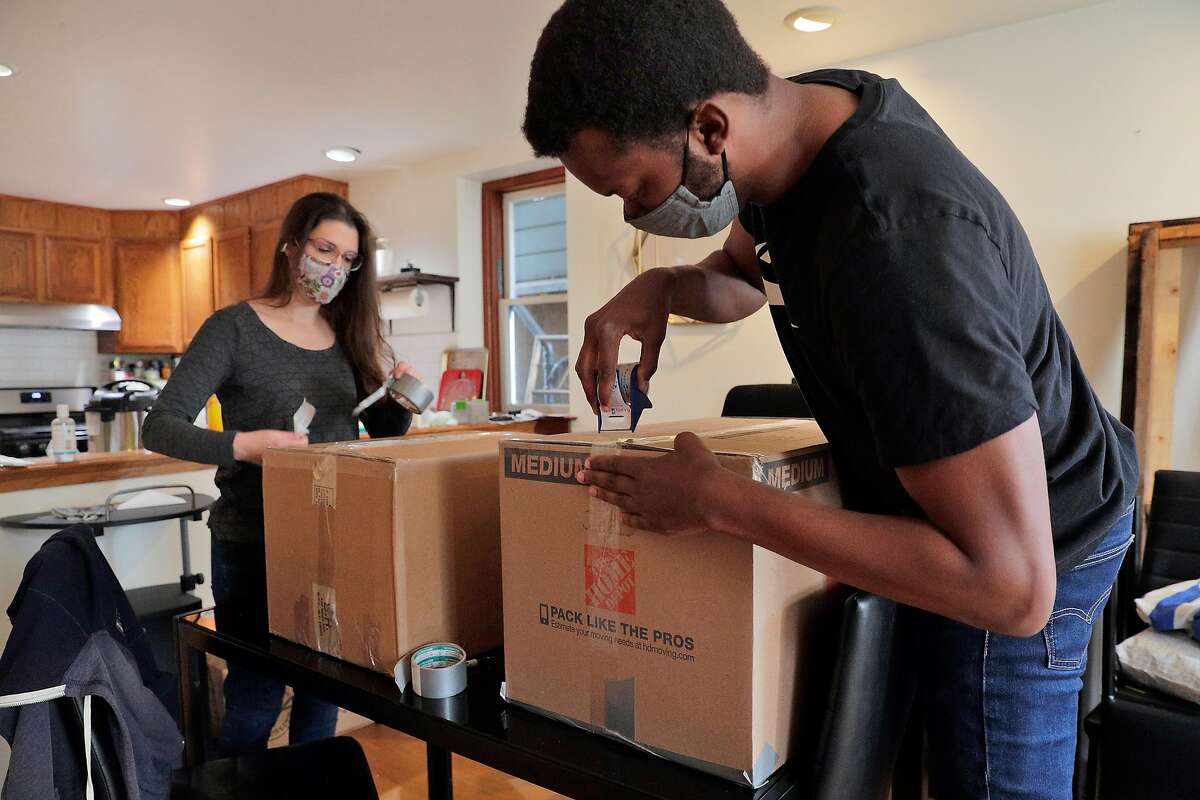 Ernest Brown and Alison Grady pack their belongings in Oakland on March 24, 2021, before their move to Atlanta. The couple decided to leave the Bay Area to buy a home in a place they could afford and start a family.