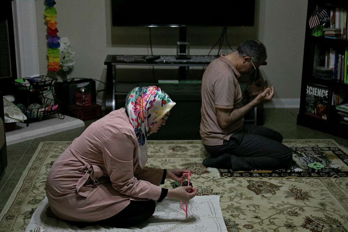 Sumeyra Tek and her husband, Suleyman Tek, pray after the Ramadan dinner at their home in San Antonio on April 15, 2021.
