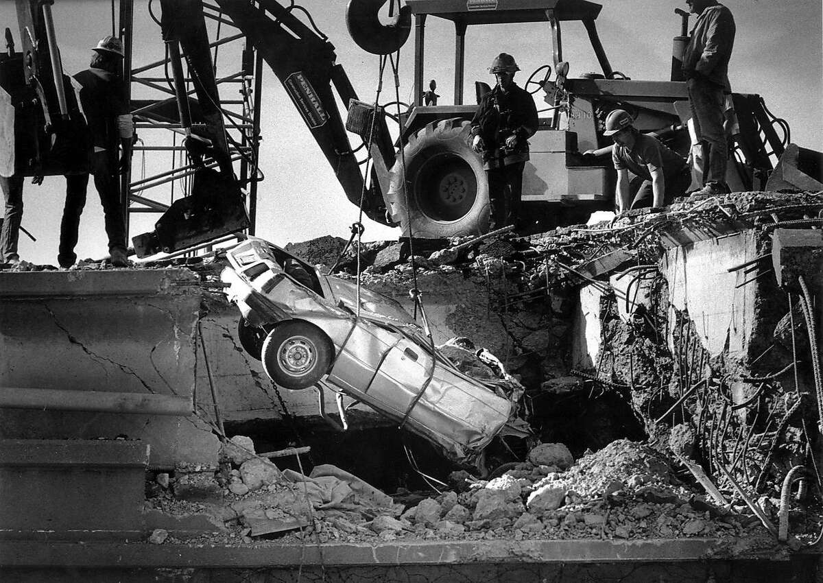A car was damaged when the Cypress Freeway collapsed on top of the lower deck in Oakland during the 1989 Loma Prieta earthquake.