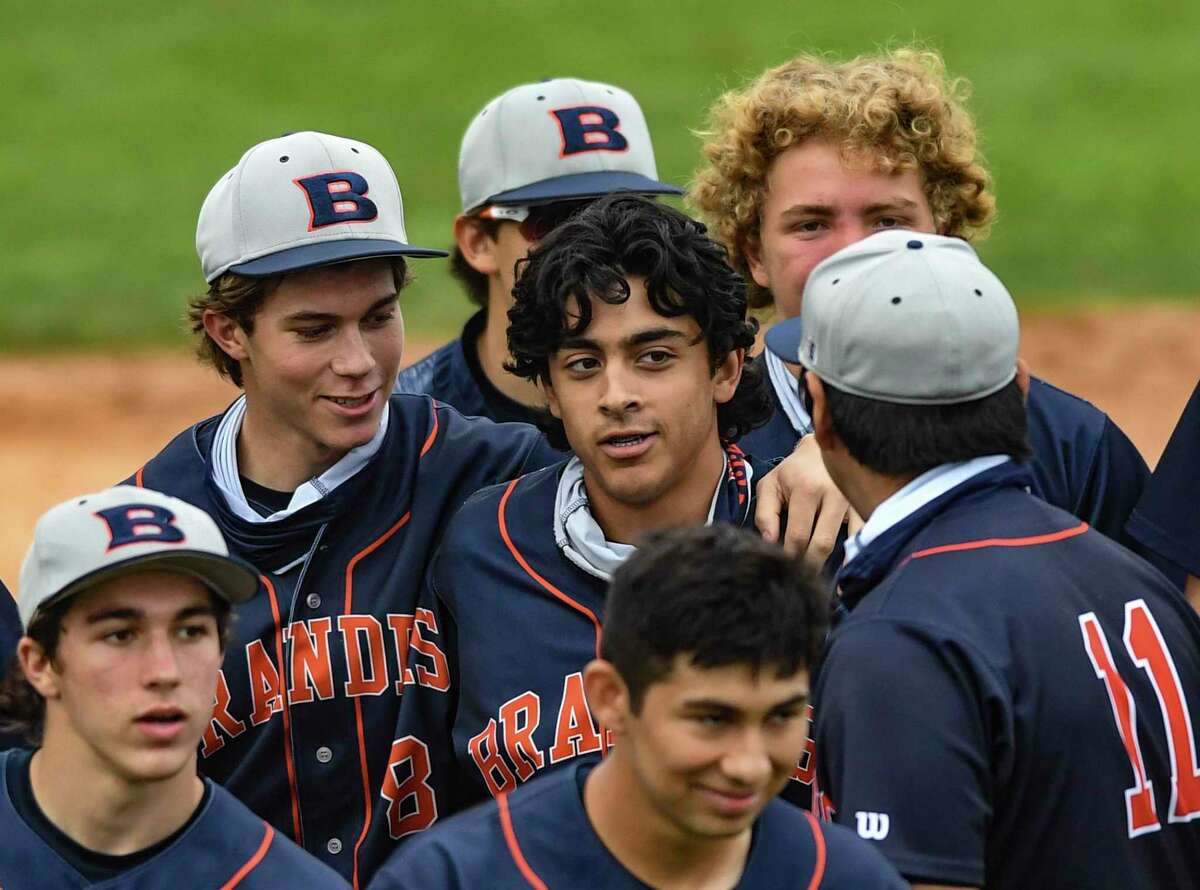 Theodore Falkenberg, middle, is surrounded by teammates after hitting a home run against Brandeis during high-school baseball action at the Blossom Athletic Center on Friday, April16, 2021.