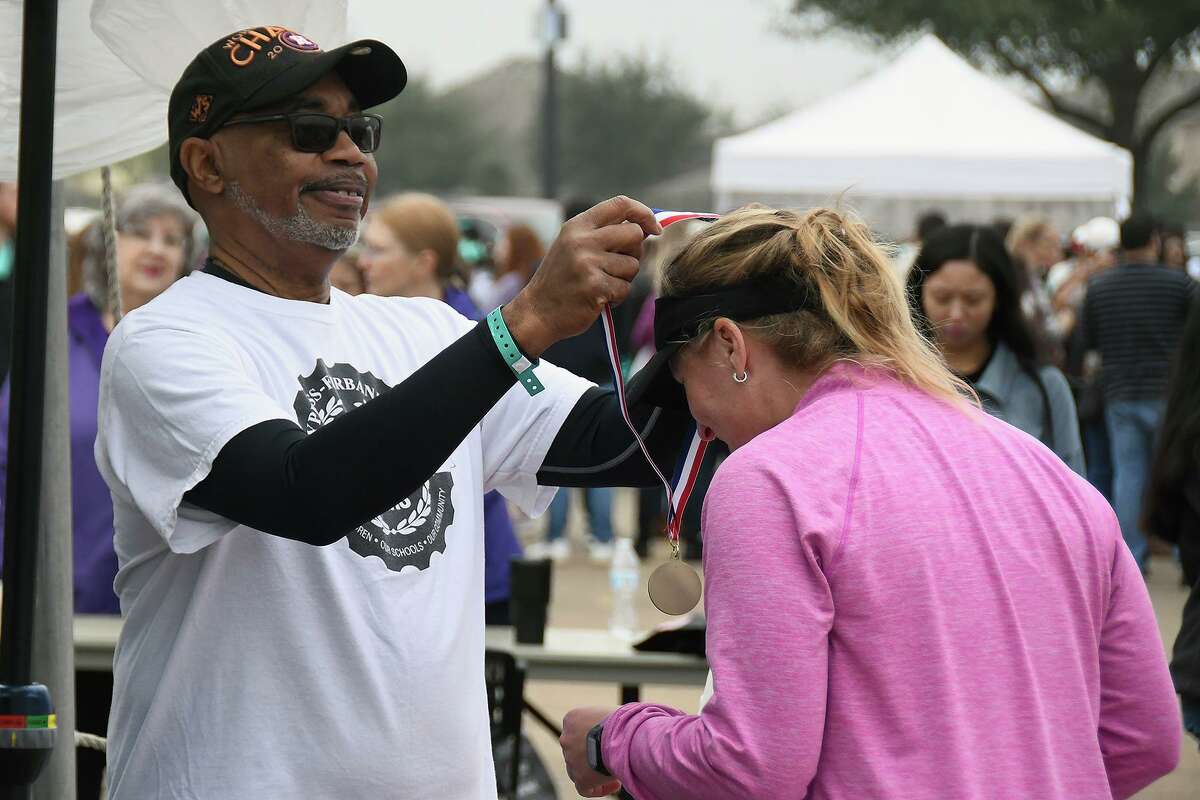 In this photo from before the pandemic, a Fun Run participant is awarded a medal. This year, the Cy-Fair ISD Superintendent's Fun Run will be virtual, encouraging participants to “run together from wherever.”
