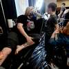 Cassie Terrell talks with her children Ethan Terrell and Alex Elliott as she gets a piece worked on by her partner Jason Elliott of College Station on the opening day of this weekend's Ink Masters Tattoo Show at the MCM Elegante in Beaumont. Renowned tattoo artists from the region will be scheduling appointments and doing walk-up tattoos, and other vendors are on-site, as well. The event continues Saturday 11 a.m. - 11 p.m., and Sunday 11 a.m. - 9 p.m. Photo made Friday, April 16, 2021 Kim Brent/The Enterprise