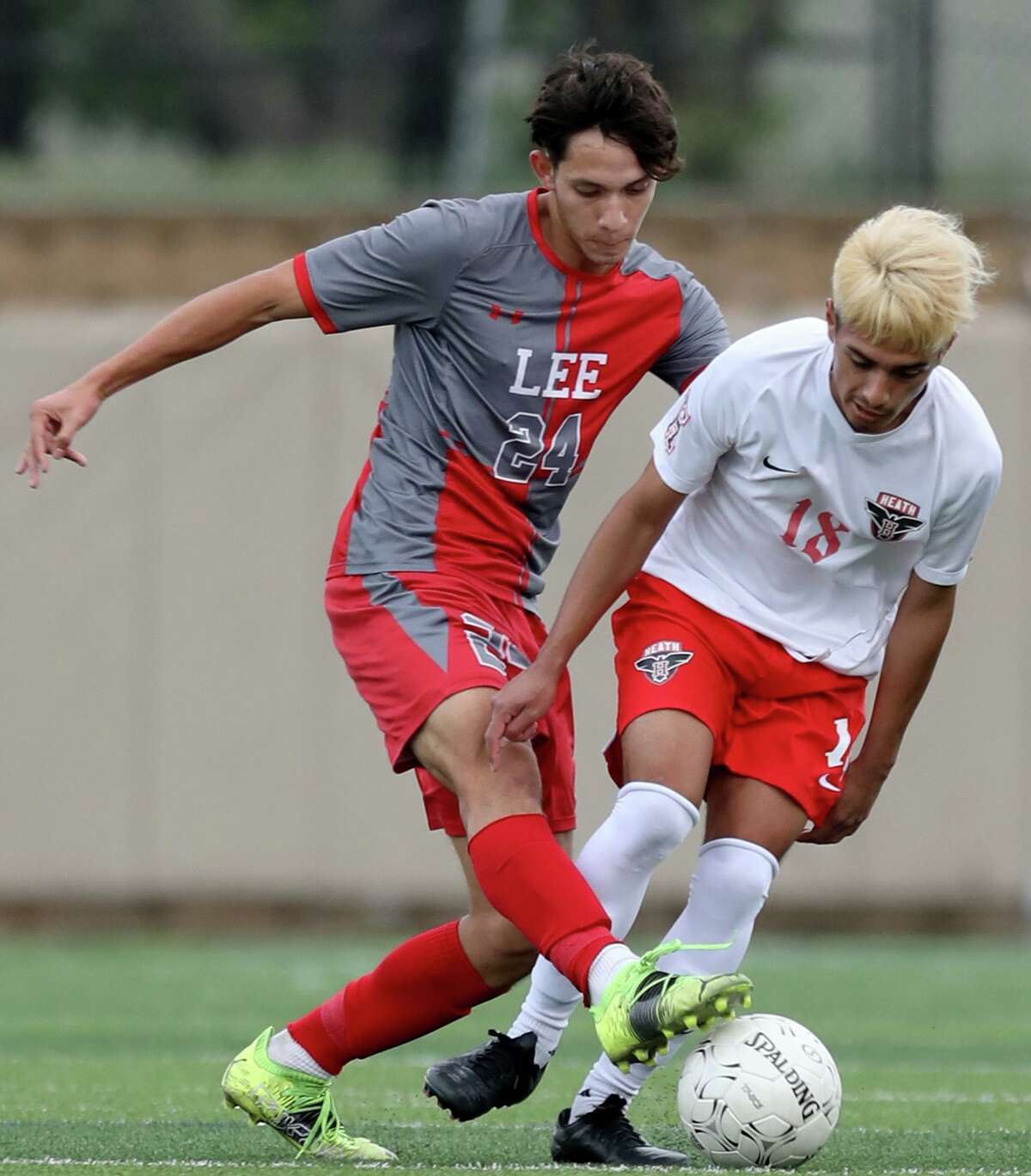 SA Lee’s Julian Sanchez (24) and Rockwall-Heath’s Luis Soto (18) struggle for control of the ball during their UIL 6A boys State championship soccer game at Birkelbach Field on April 17, 2021 in Georgetown, Texas.