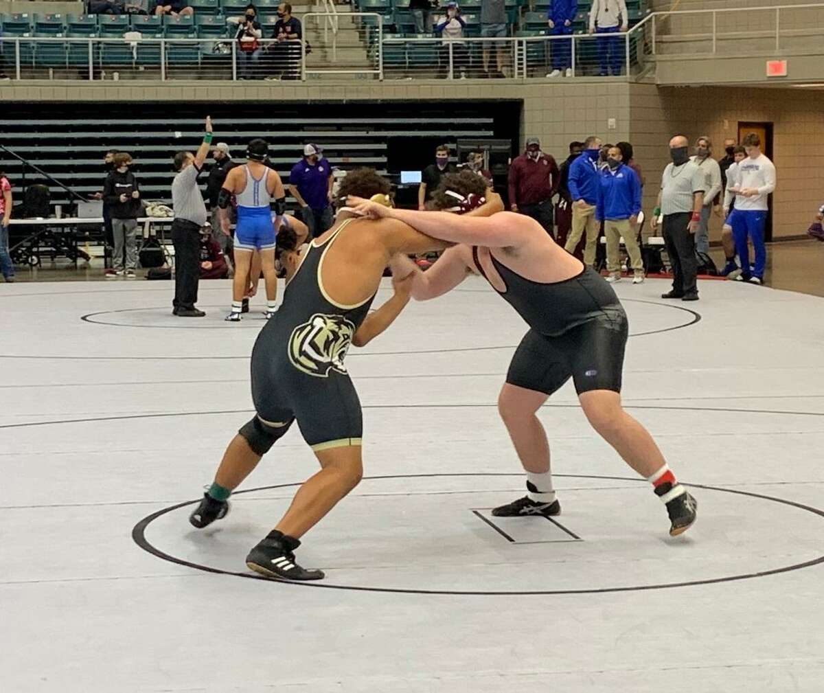 George Ranch's Austin Stubbs and Cypress Park's Jarra Anderson compete for the 285-pound championship at the Region III-6A tournament April 17 at Merrell Center.