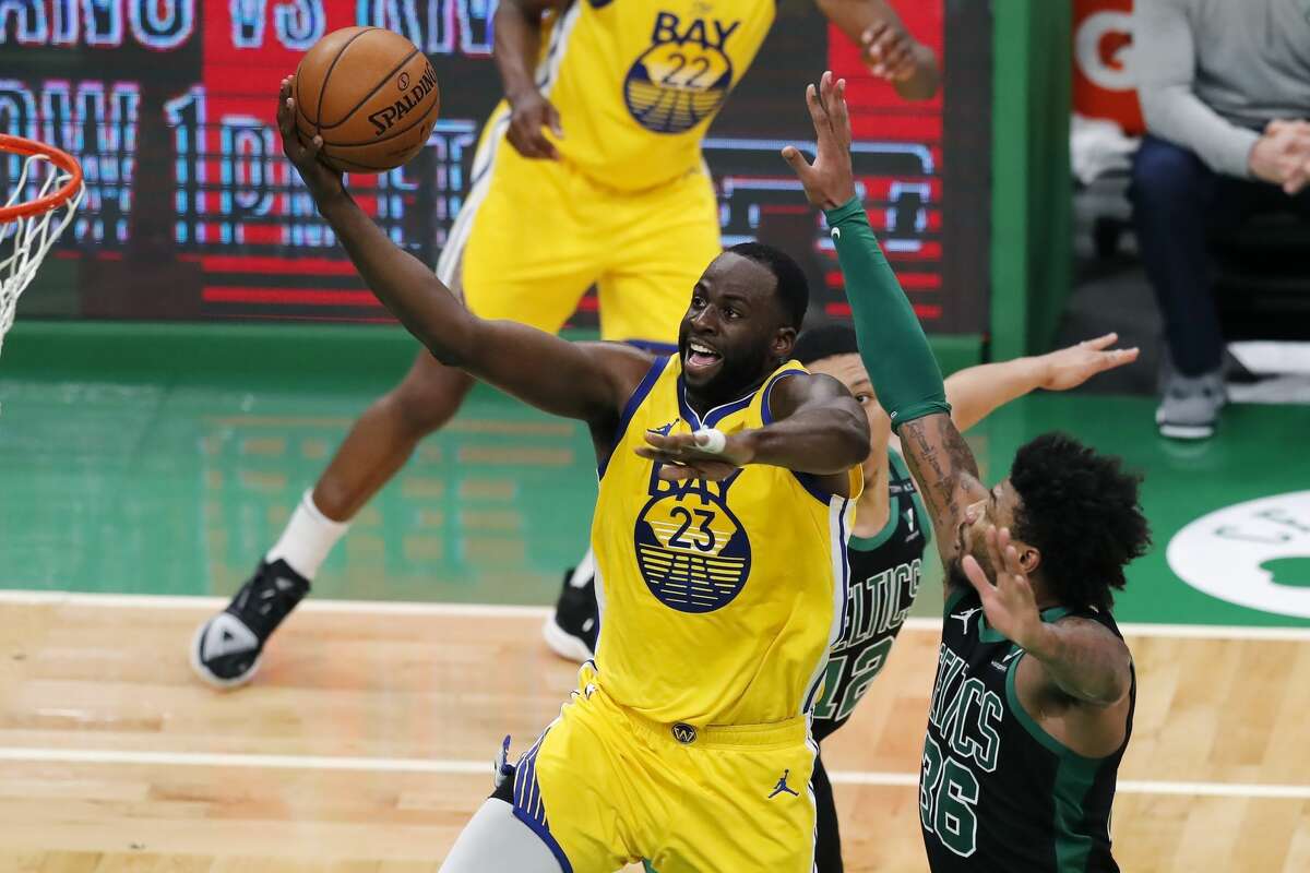 Golden State Warriors' Draymond Green shoots against Boston Celtics' Marcus Smart during the second half of an NBA basketball game on April 17, 2021.