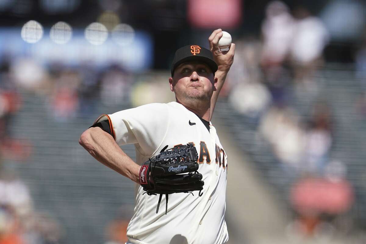 San Francisco Giants pitcher Jake McGee throws to a Cincinnati Reds batter during the ninth inning of a baseball game in San Francisco, Wednesday, April 14, 2021. (AP Photo/Jeff Chiu)