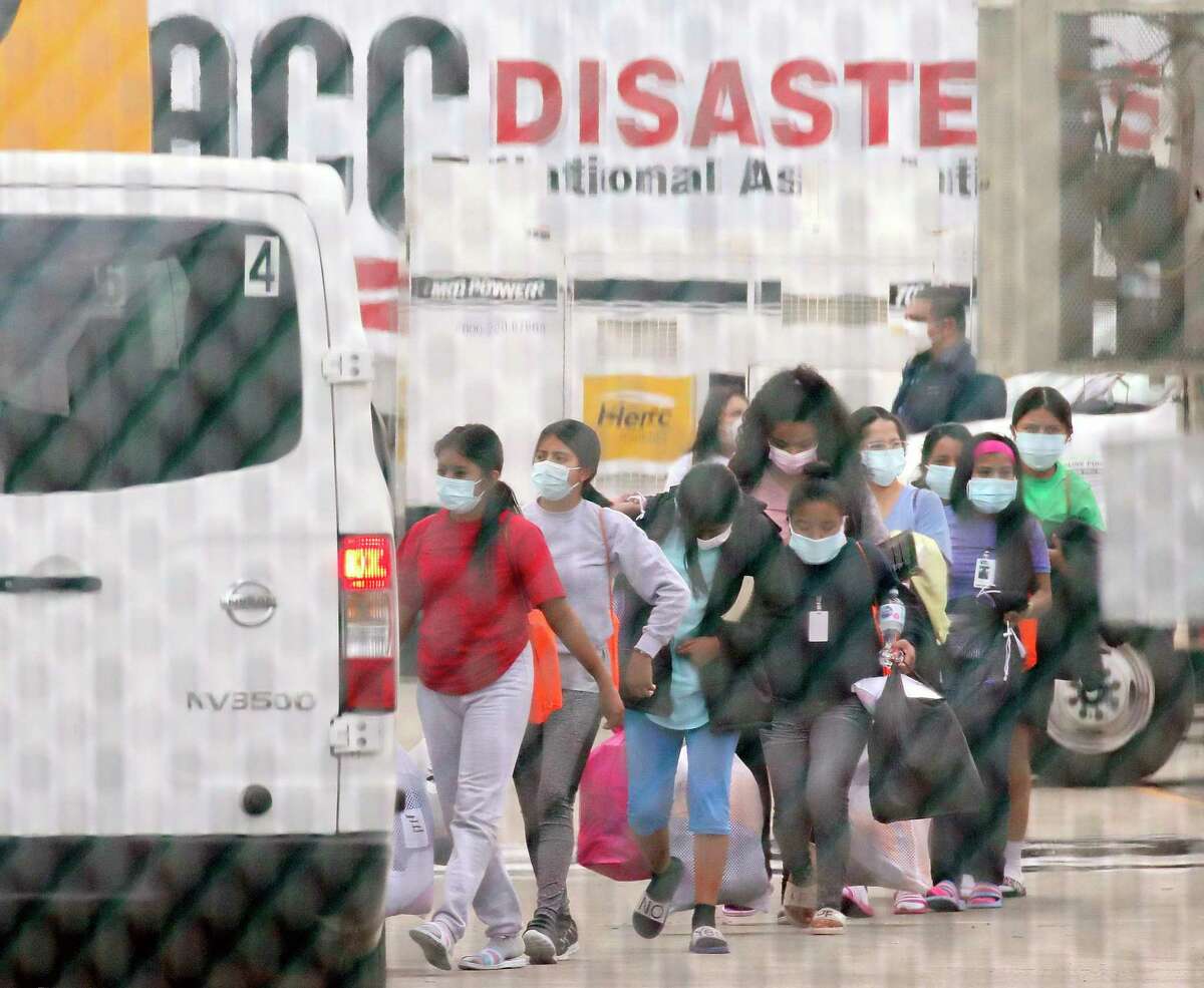 Teenage migrant girls are loaded into vans to be transported out of the National Association of Christian Churches facility, on Saturday, April 17, 2021, in Houston. A facility in Houston that housed girls who crossed U.S. border unaccompanied is being closed and the girls immediately moved, the U.S. Department of Health and Human Services said Saturday.