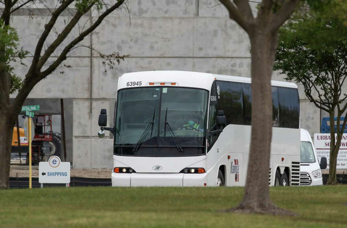 Teenage migrant girls are transported out of the National Association of Christian Churches facility in buses on Saturday, April 17, 2021, in Houston.
