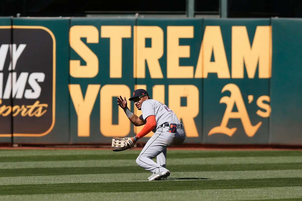 Center fielder Victor Reyes #22 of the Detroit Tigers loses the ball in the sun allowing a double by Matt Olson #28 of the Oakland Athletics in the bottom of the ninth inning at RingCentral Coliseum on April 18, 2021 in Oakland, California.