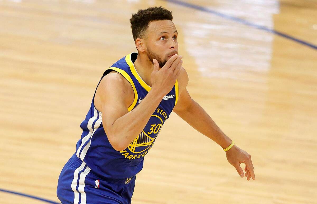 Stephen Curry #30 of the Golden State Warriors blows a kiss after he made a basket to pass Wilt Chamberlain as the Golden State Warriors all-time leading scorer during the first quarter of their game against the Denver Nuggets at Chase Center on April 12, 2021 in San Francisco, California. (Ezra Shaw/Getty Images/TNS)