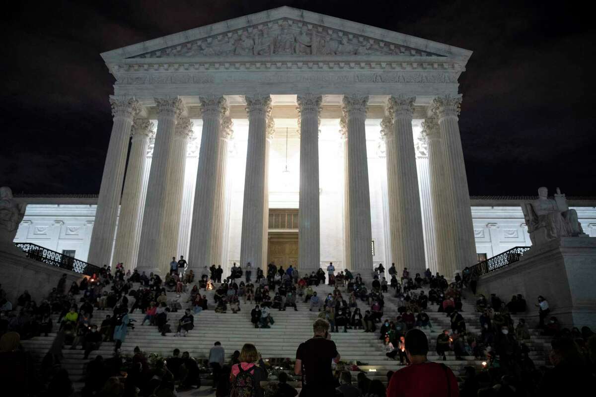 People gather to mourn the death of Supreme Court Justice Ruth Bader Ginsburg, at the steps in front of the Supreme Court on Friday, Sept. 18, 2020, in Washington, D.C. Ginsburg has died at age 87 after a battle with pancreatic cancer. (Tasos Katopodis/Getty Images/TNS)