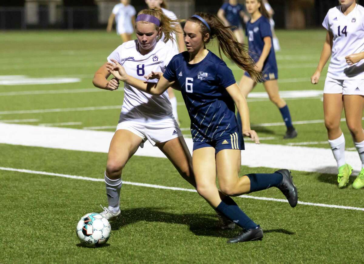 Lake Creek Morgan McGee (6) and Montgomery midfielder Mable Pruter (8) fight for control of a throw in during the first half of a District 20-5A girls soccer game at Lake Creek High School, Friday, Feb. 26, 2021, in Montgomery.