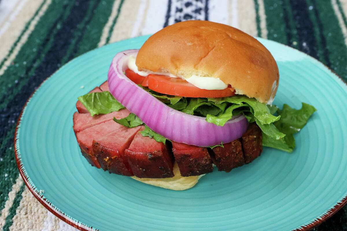 Chuck Blount's smoked bologna sandwich made with a half-pound slice of smoked bologna, lettuce, sliced tomato and onion, mayonnaise and a bakery bun.