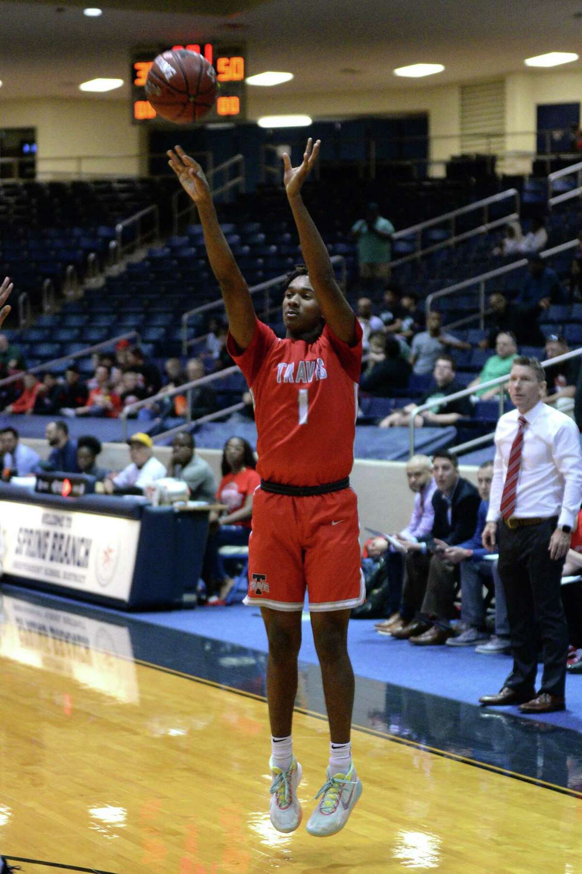 Mekhi McIntyre (1) of Travis attempts a 3-point shot during the third quarter of a Boys 6A Region III Bi-District play-off game between the Mayde Creek Rams and the Travis Tigers on Tuesday, February 25, 2020 at Coleman Coliseum, Houston, TX.