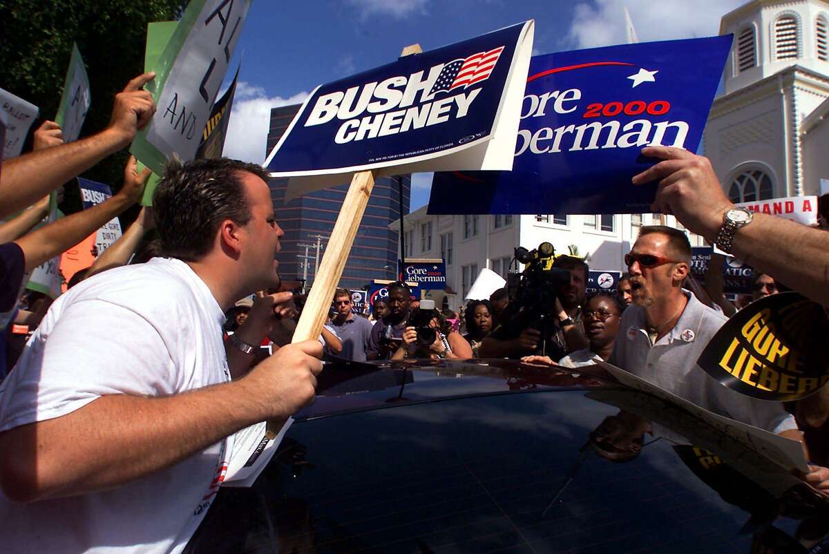 Supporters of Republican presidential candidate Texas Gov. George W. Bush argue with supporters of Democratic presidential candidate Vice President Al Gore outside the County Administration complex Thursday, Nov. 9, 2000, in West Palm Beach, Fla.