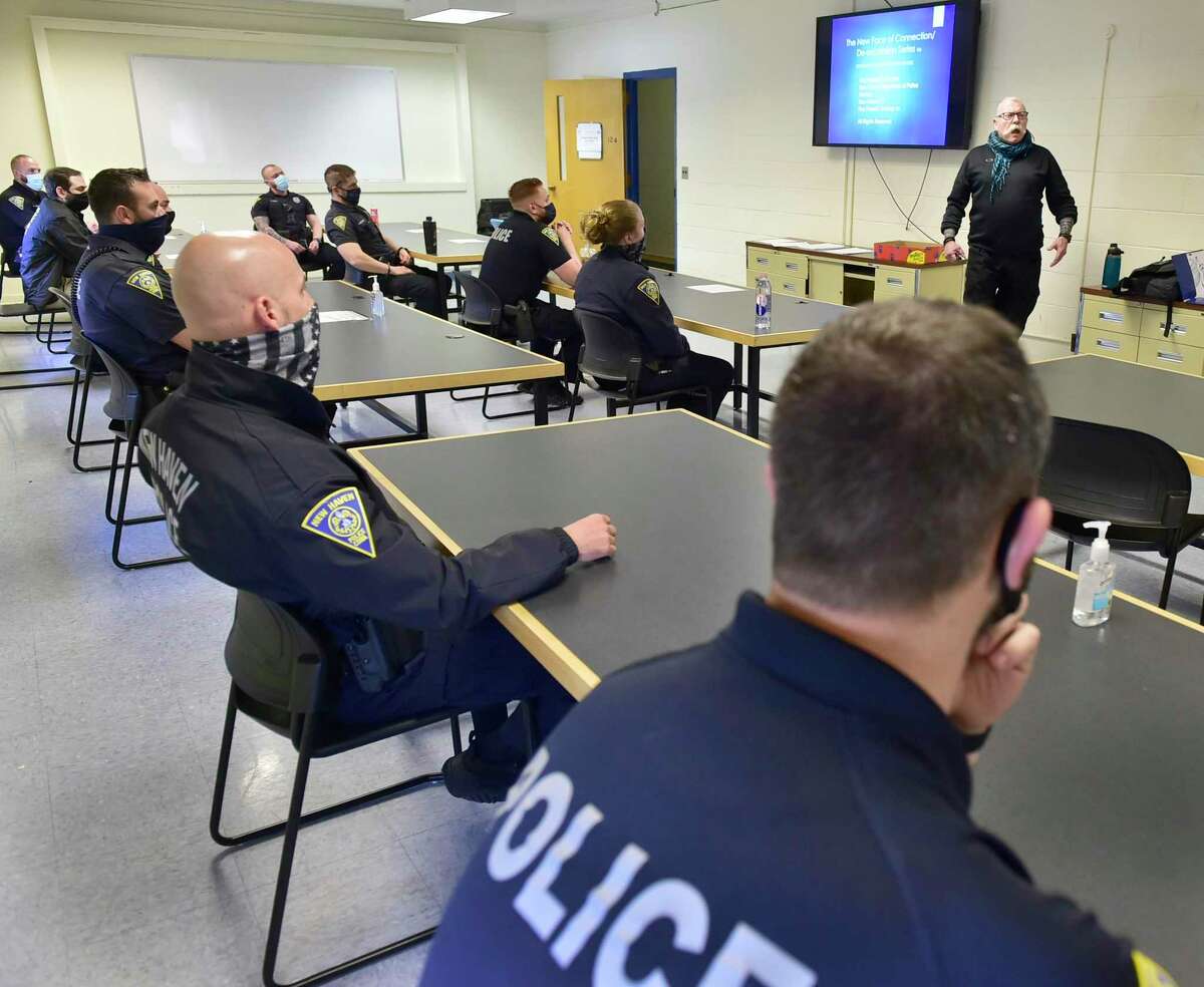 Retired New Haven police Lt. Raymond Hassett, front right, will be conducting de-escalation training for the NHPD, announced Monday during a press conference at the New Haven Police Department training academy on Wintergreen Avenue.