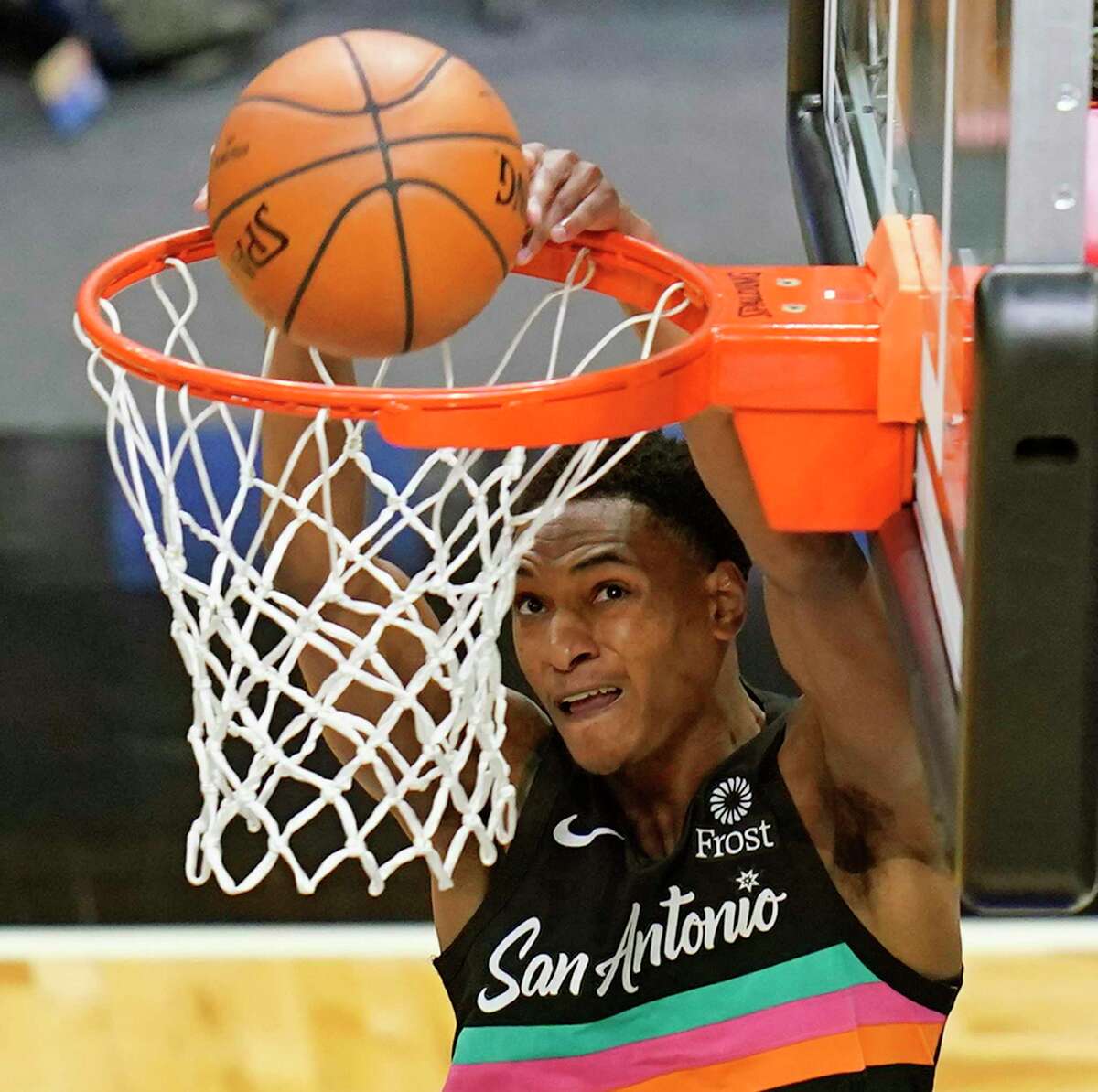 Spurs guard Devin Vassell (24) dunks the ball against the Orlando Magic during the second half of an NBA basketball game, Monday, April 12, 2021, in Orlando, Fla.
