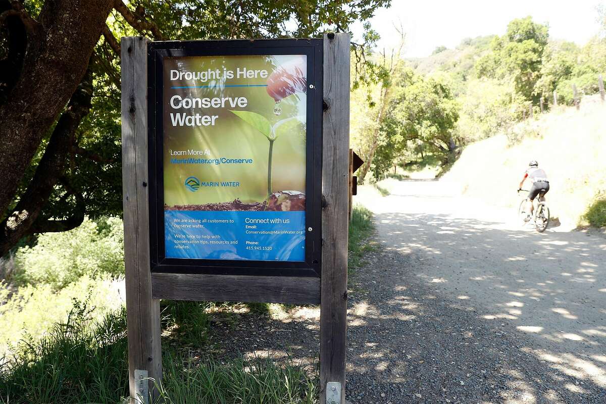 A sign urges water conservation in Marin County. The Marin Municipal Water District has imposed mandatory water restrictions.