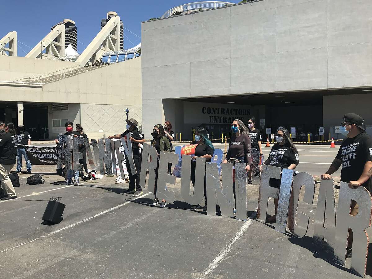 Activists gather outside the San Diego Convention Center, where 1,450 migrant children are being held in a federal shelter after being transferred from overflowing Texas border facilities.