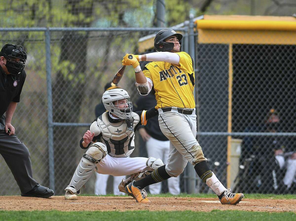 Amity's Sebastian Holt bashes a two run home run to give his team a 4-3 lead over visiting Daniel Hand during the 3rd inning of their baseball game at Amity High School in Woodbridge, Conn. on Monday, April 19, 2021.