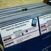 Laminated instructions for operating an electronic voting machine Friday, Sept. 25, 2020, at NRG Arena in Houston.