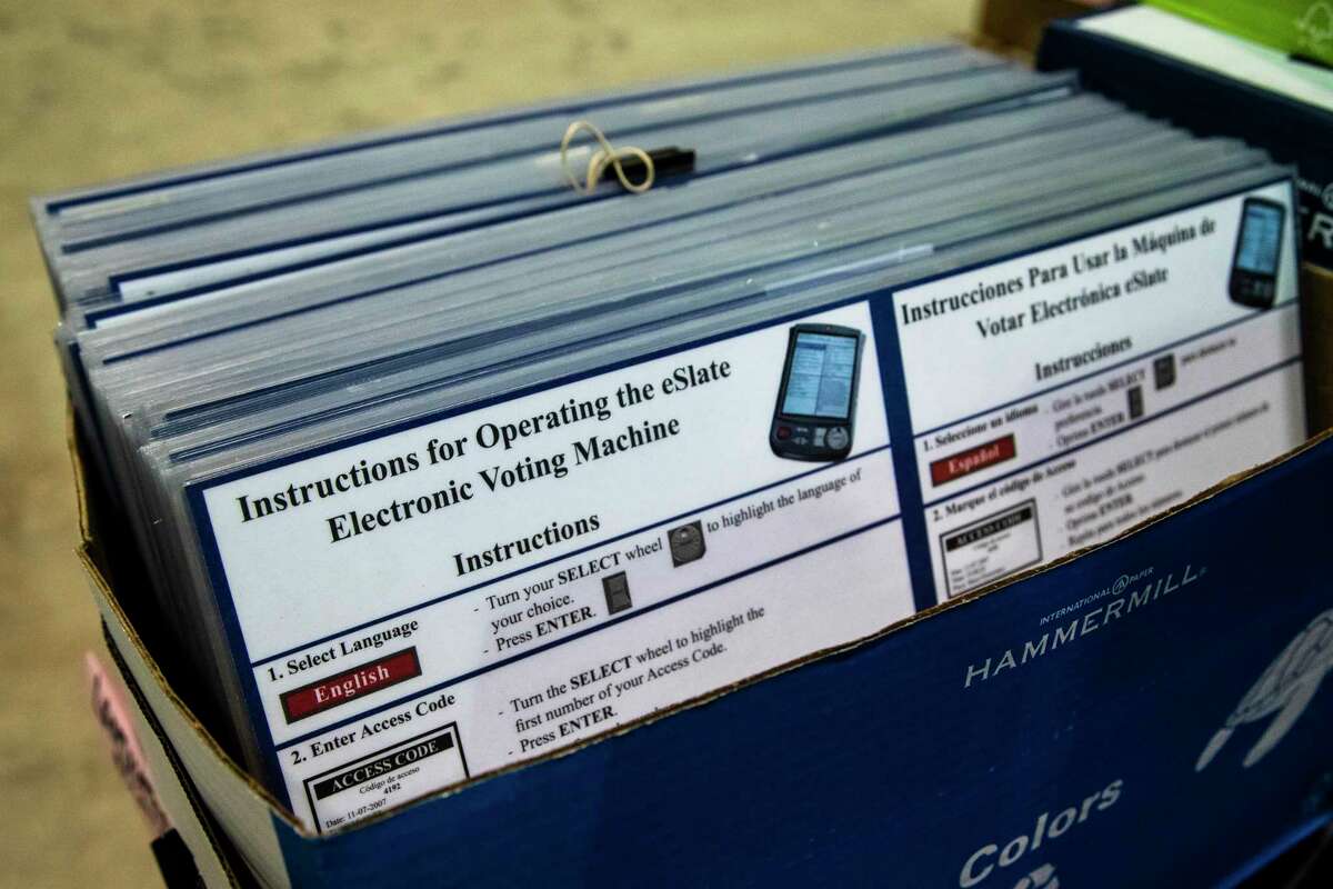 Laminated instructions for operating an electronic voting machine Friday, Sept. 25, 2020, at NRG Arena in Houston.