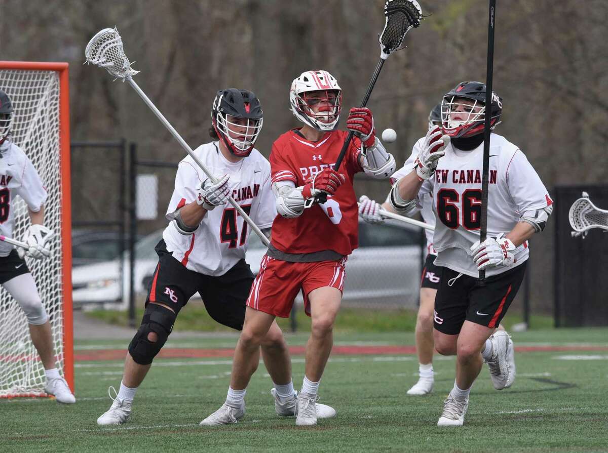 Fairfield Prep's Tyler Fox (6) and New Canaan's Dillon Stephens (47) and Christian Wolter (66) battle for a loose ball during a boys lacrosse game at Dunning Field on Monday, April 19, 2021.