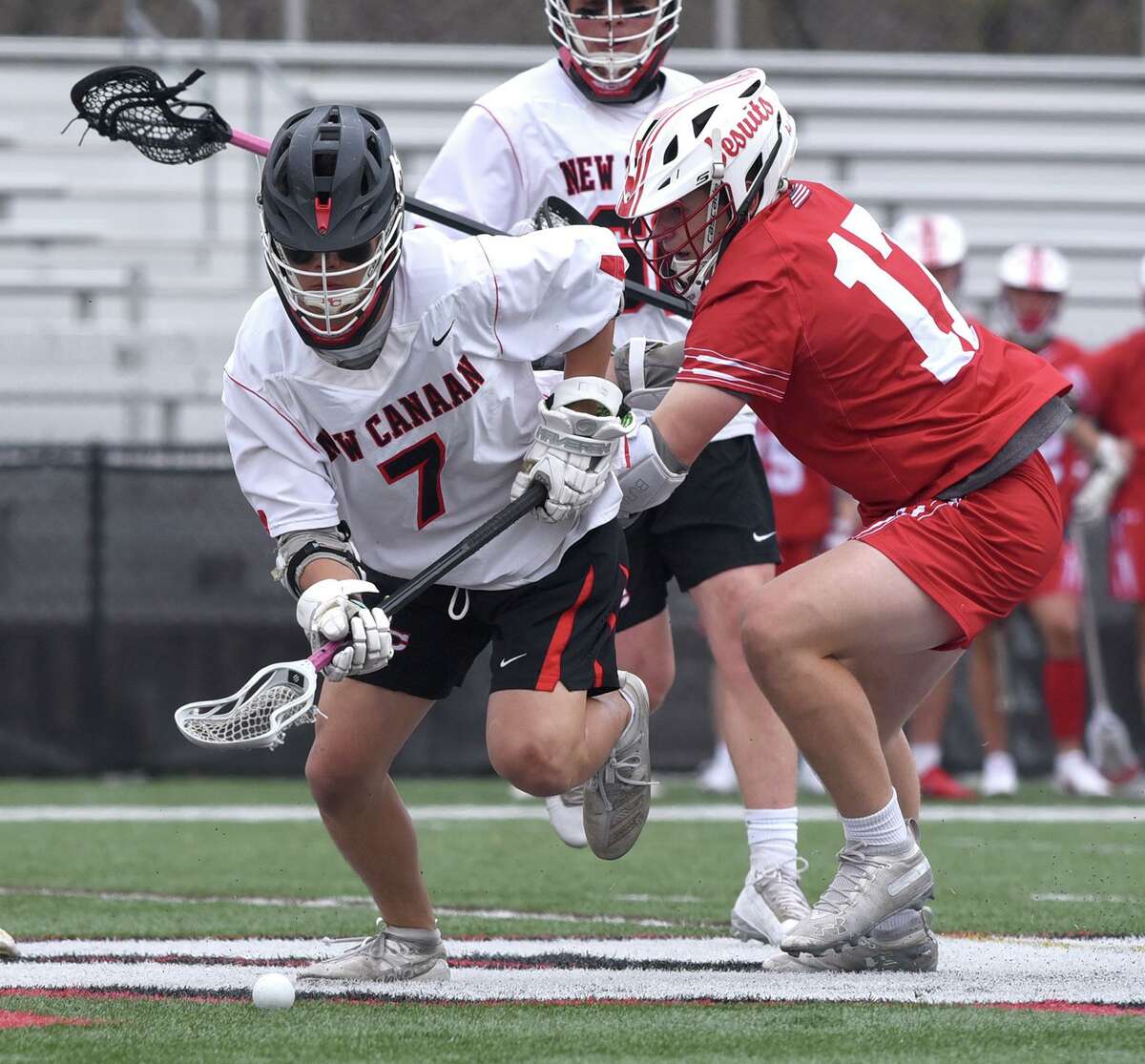 New Canaan's Hayden Shin (7) and Fairfield Prep's Ted Bednar (17) scramble for the ball on a faceoff during a boys lacrosse game at Dunning Field on Monday, April 19, 2021.