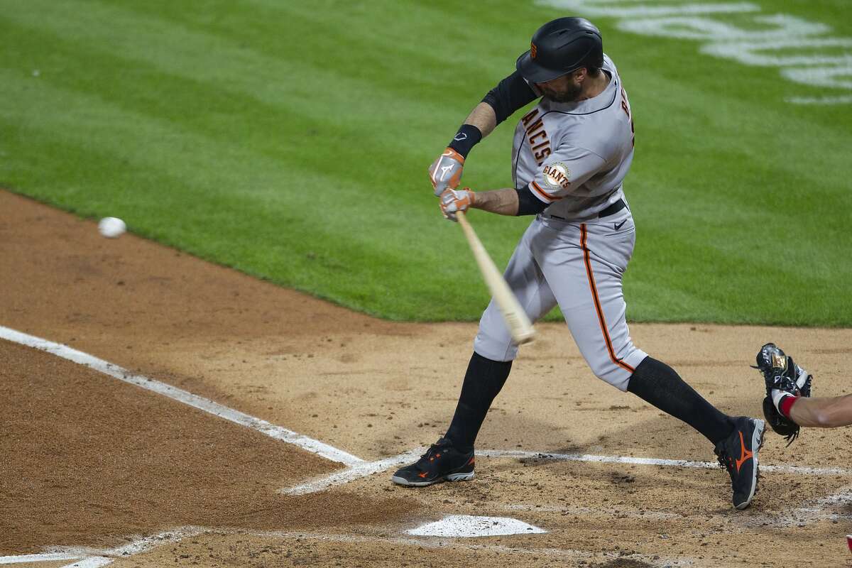 The Giants’ Brandon Belt hits a two-run homer in the third, which stood up in a 2-0 victory.