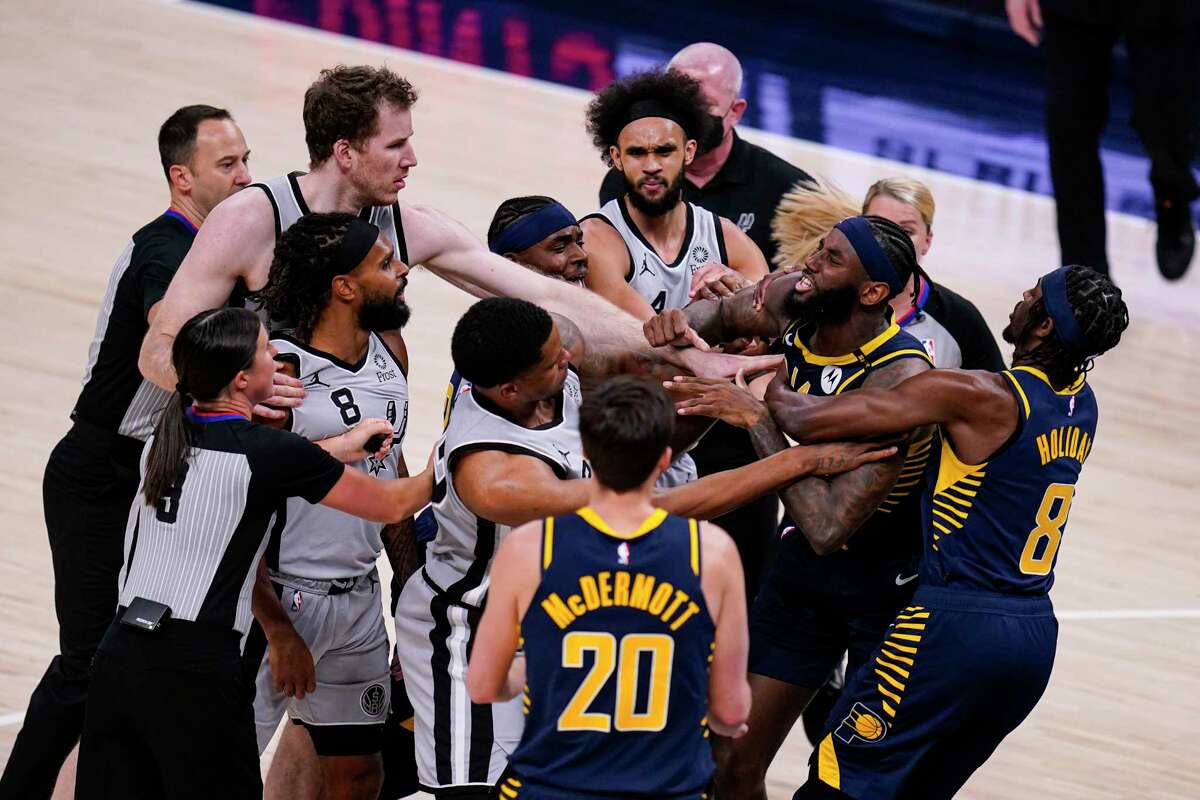 Pacers forward JaKarr Sampson (14) and San Spurs guard Patty Mills (8) exchange words during the second half of an NBA basketball game in Indianapolis, Monday, April 19, 2021. Sampson was ejected from the game.