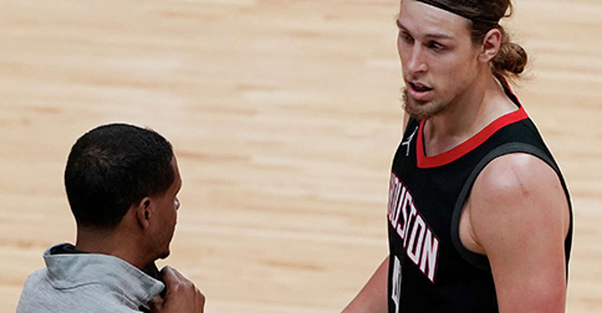 Houston Rockets head coach Stephen Silas talks to forward Kelly Olynyk during the first half of an NBA basketball game against the Miami Heat, Monday, April 19, 2021, in Miami. (AP Photo/Marta Lavandier)
