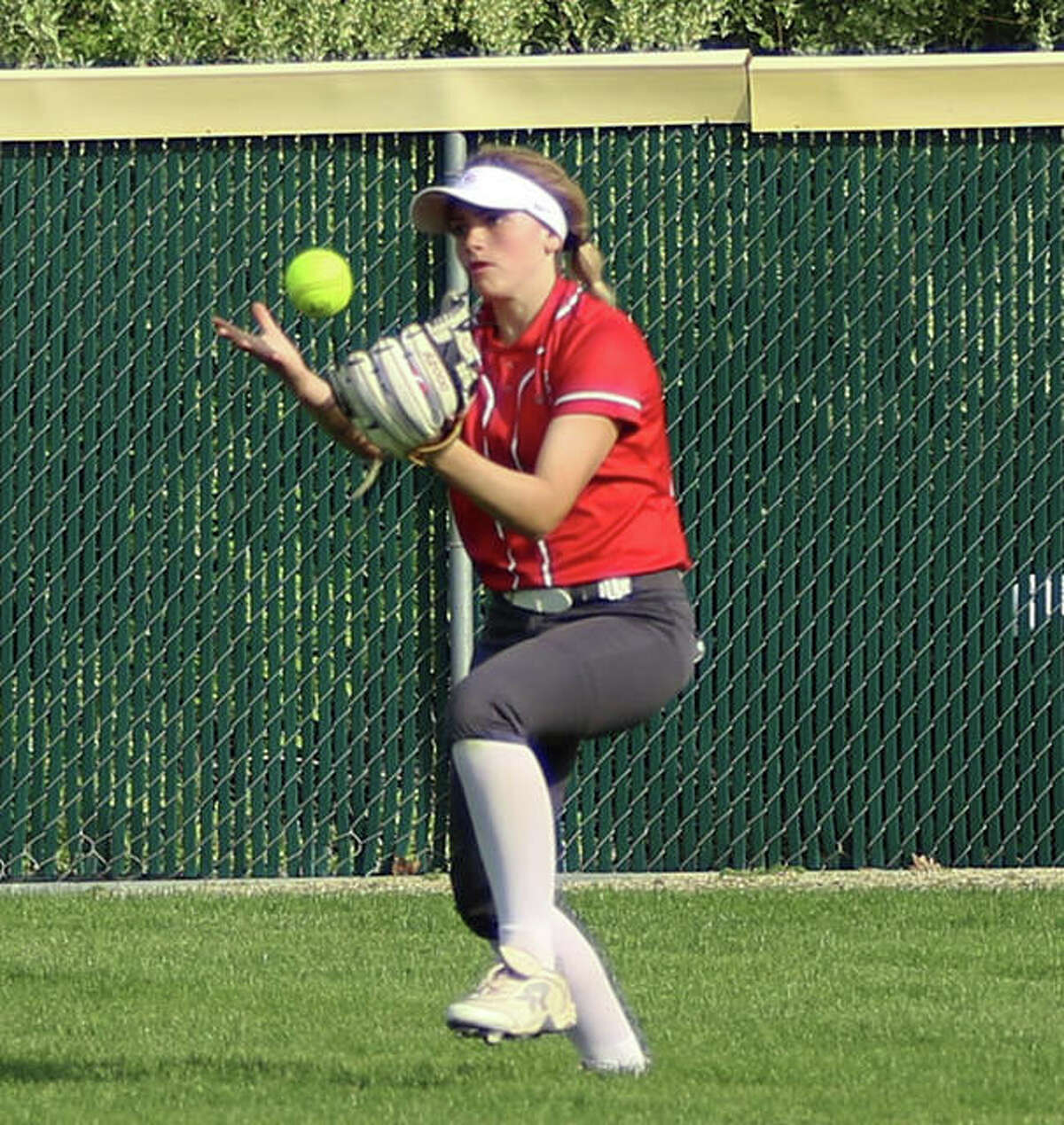 Alton right fielder Lauren O’Neill bobbles a fly ball, but makes the catch against Triad on Monday at Alton High in Godfrey.
