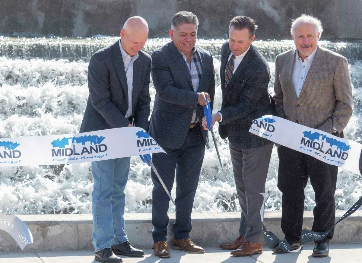 Richard Dealy, President and Chief Operating Officer, former mayor Jerry Morales, Mayor Patrick Payton and Mark Berg, Executive Vice President, Corporate Operations with Pioneer Natural Resources, cut the ribbons 04/20/2021 at the kick-off event of the joint venture of Pioneer Natural Resources and City of Midland at the City of Midland Water Reclamation Facility. Pioneer will soon be able to utilize 240,000-250,000 barrels of water a day for drilling purposes after cleaning the waste water at the facility. Tim Fischer/Reporter-Telegram