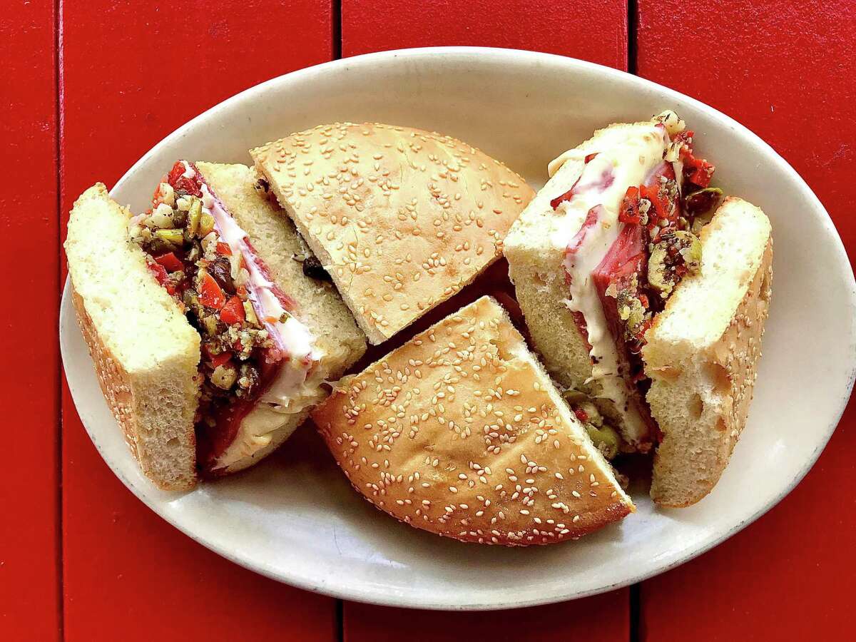 Ragin' Cajun in Houston calls its muffuletta sandwich a "muffalotta" but it is constructed in a classic manner with Italian meats, cheeses and olive salad on a sesame seed loaf. It is served toasted.