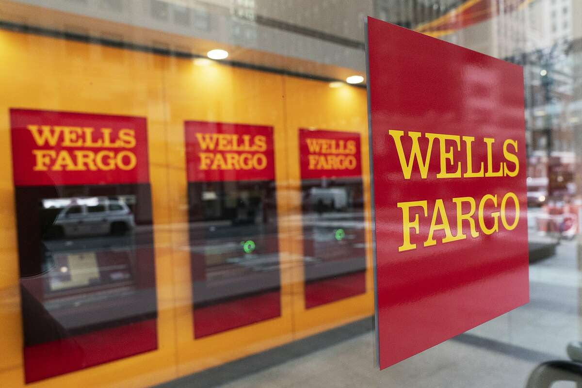 FILE - This Jan. 13, 2021 file photo shows a Wells Fargo office in New York. Wells Fargo & Co. says first-quarter net income jumped to $4.74 billion from $653 million a year earlier, when the pandemic struck the global economy. The San Francisco-based bank said Wednesday, April 14, that it had earnings of $1.05 per share in the latest quarter, compared with a profit of 1 cents a year earlier. (AP Photo/Mark Lennihan, File)